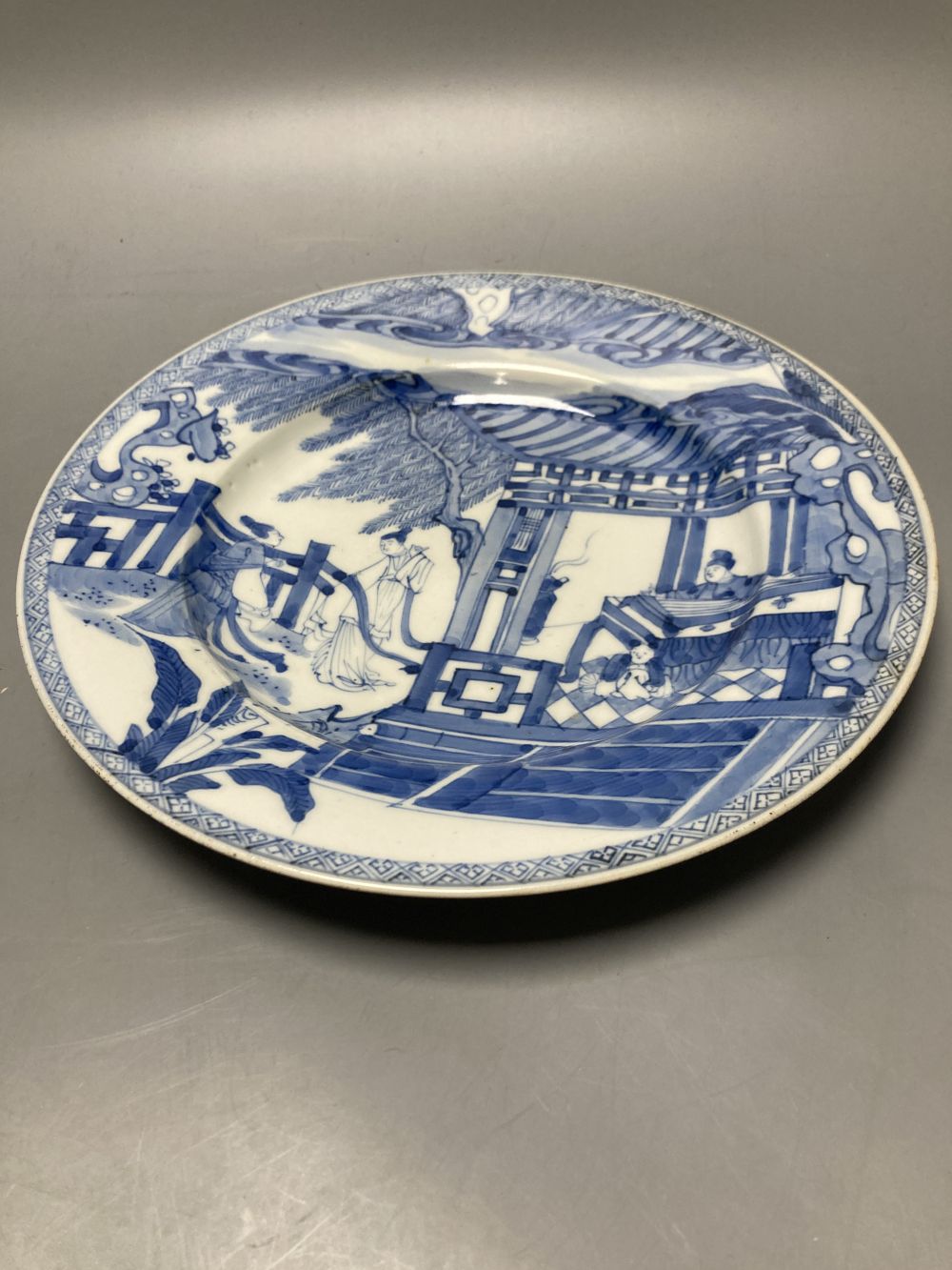 An 18th century Chinese famille rose plate together with a Chinese blue and white plate and a famille rose mug lacking handle, largest